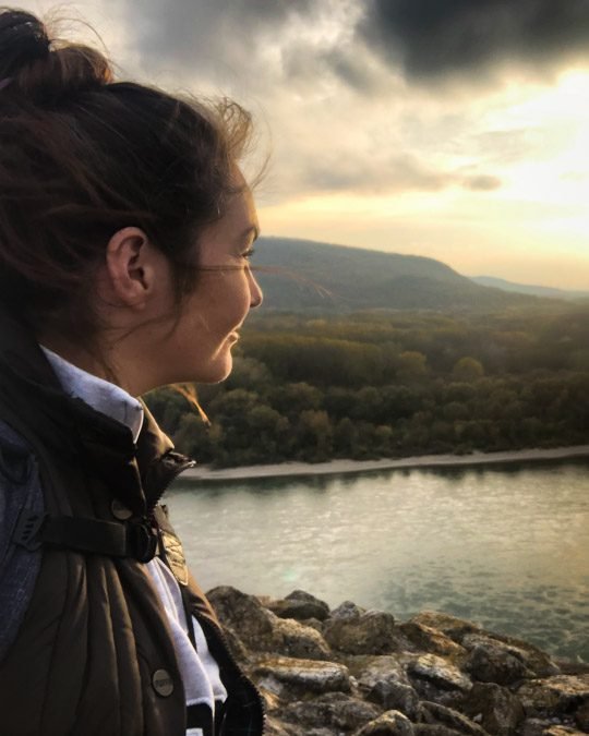 Travel Blogger stopping to watch the sunset over Devin Castle in Slovakia whilst on a day hike from Bratislava