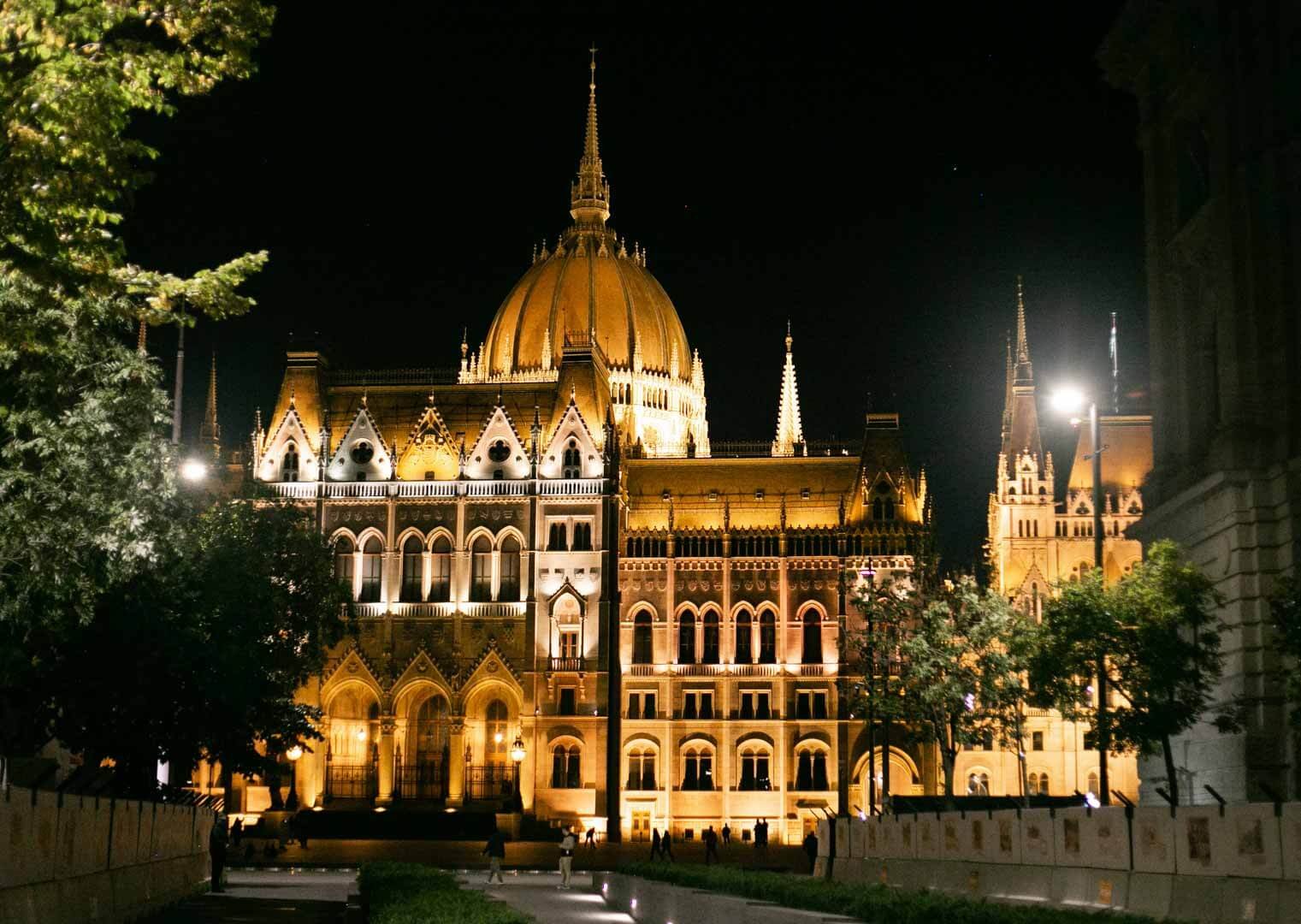Hungarian Parliament Building illuminated at night beside the Danube River in Budapest, Hungary